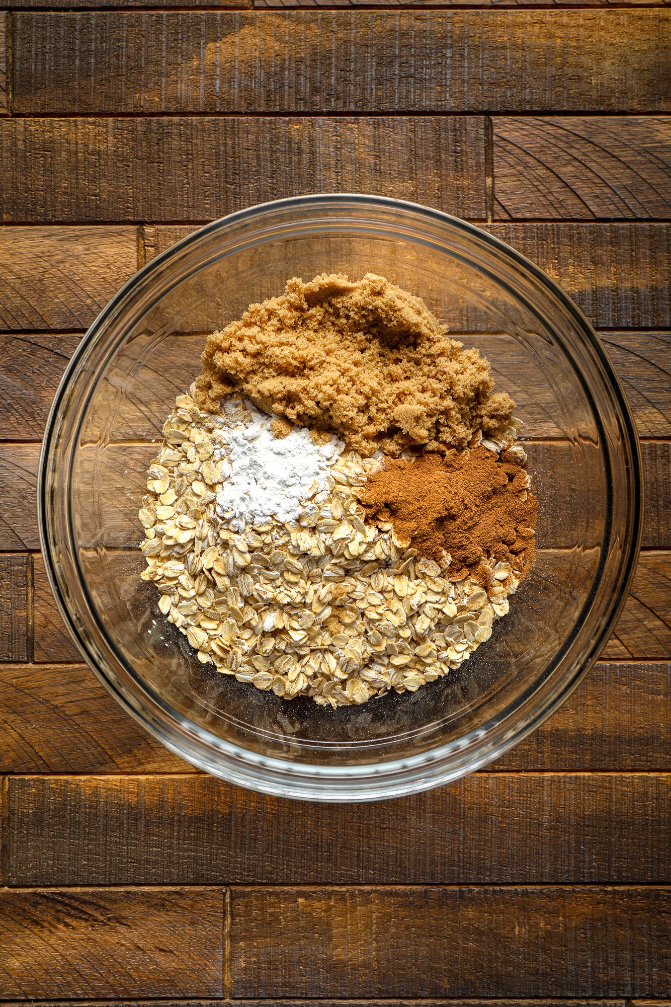 ingredients for pumpkin baked oatmeal together in a glass bowl.