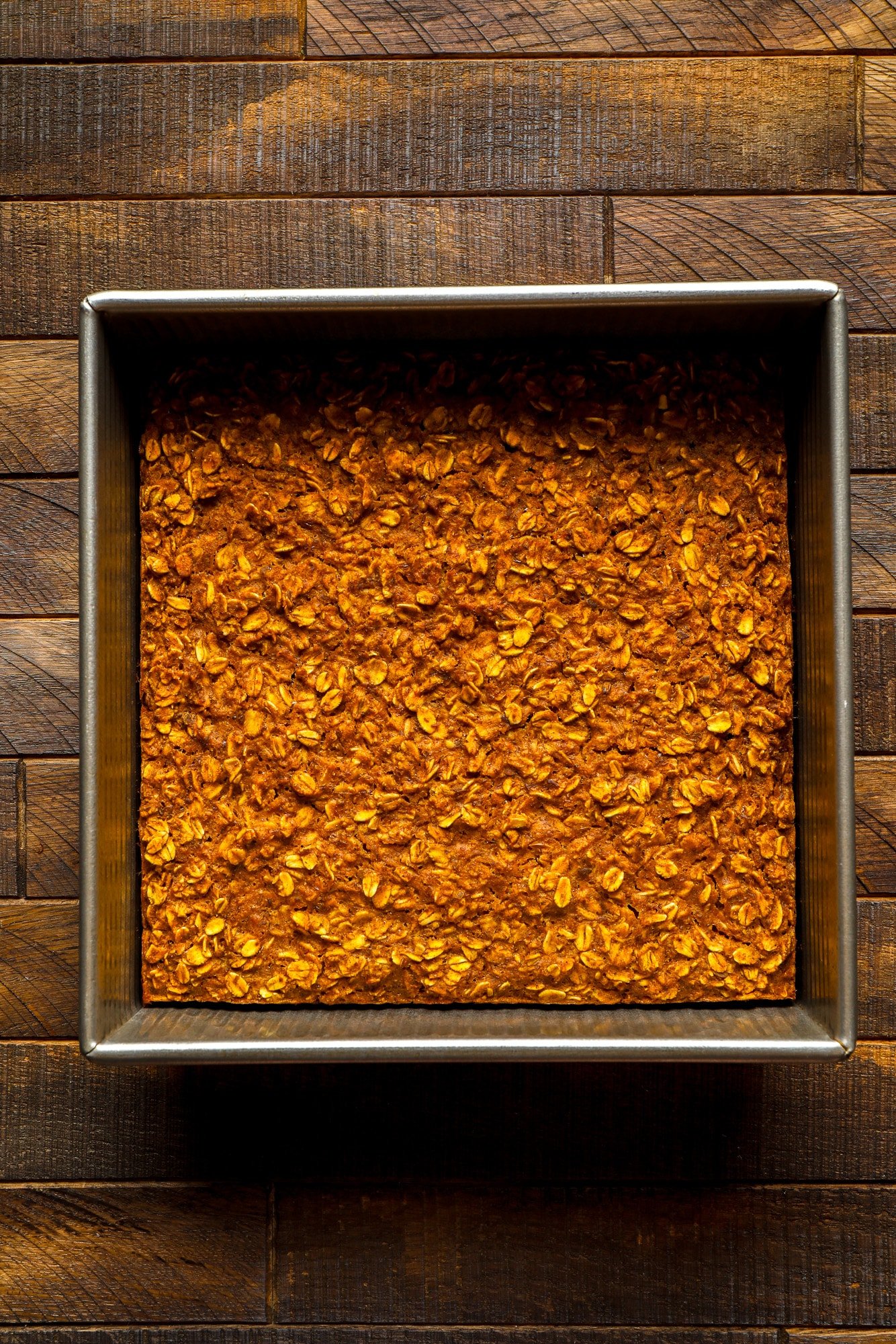 baked pumpkin oatmeal in a square metal baking pan.