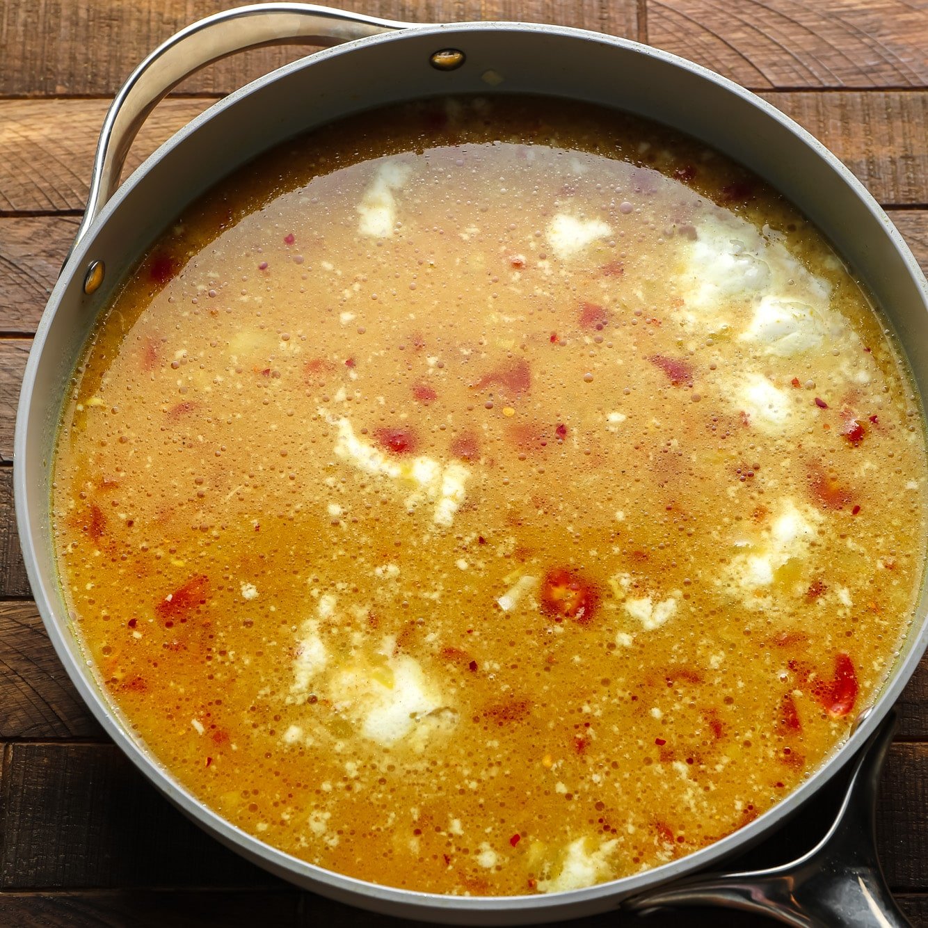 uncooked lentil dal in a large grey pot.