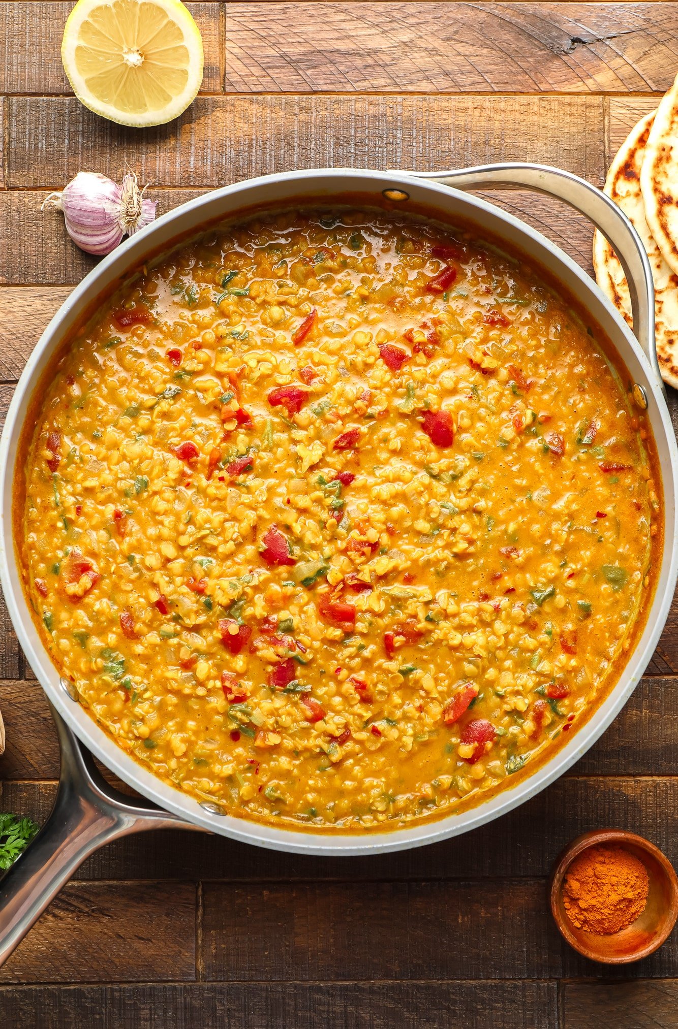 a cooked batch of lentil dahl in a large grey pot.