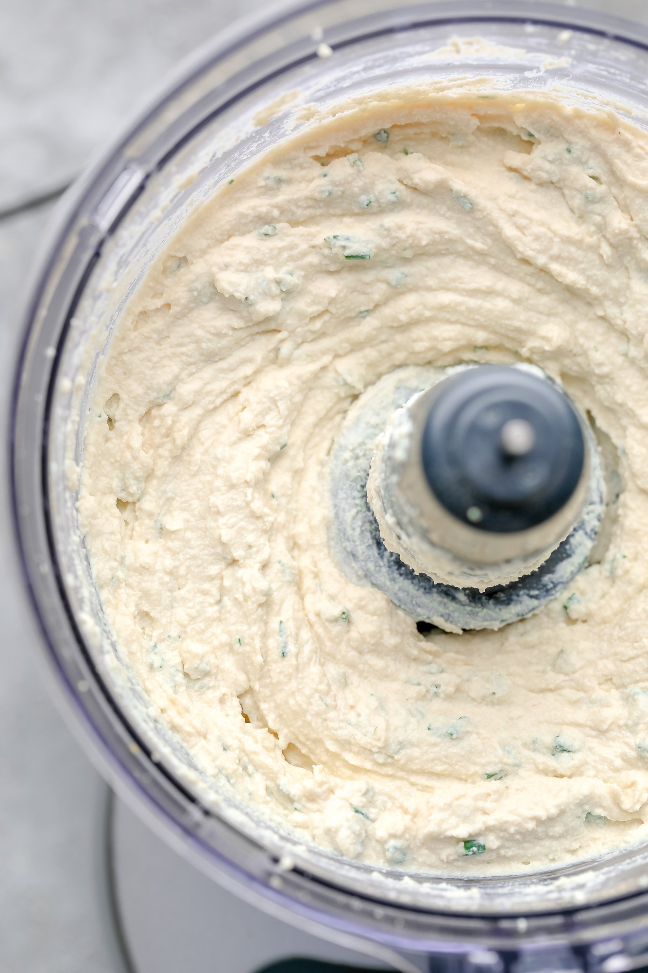 close up on blended tofu cream cheese in a food processor.