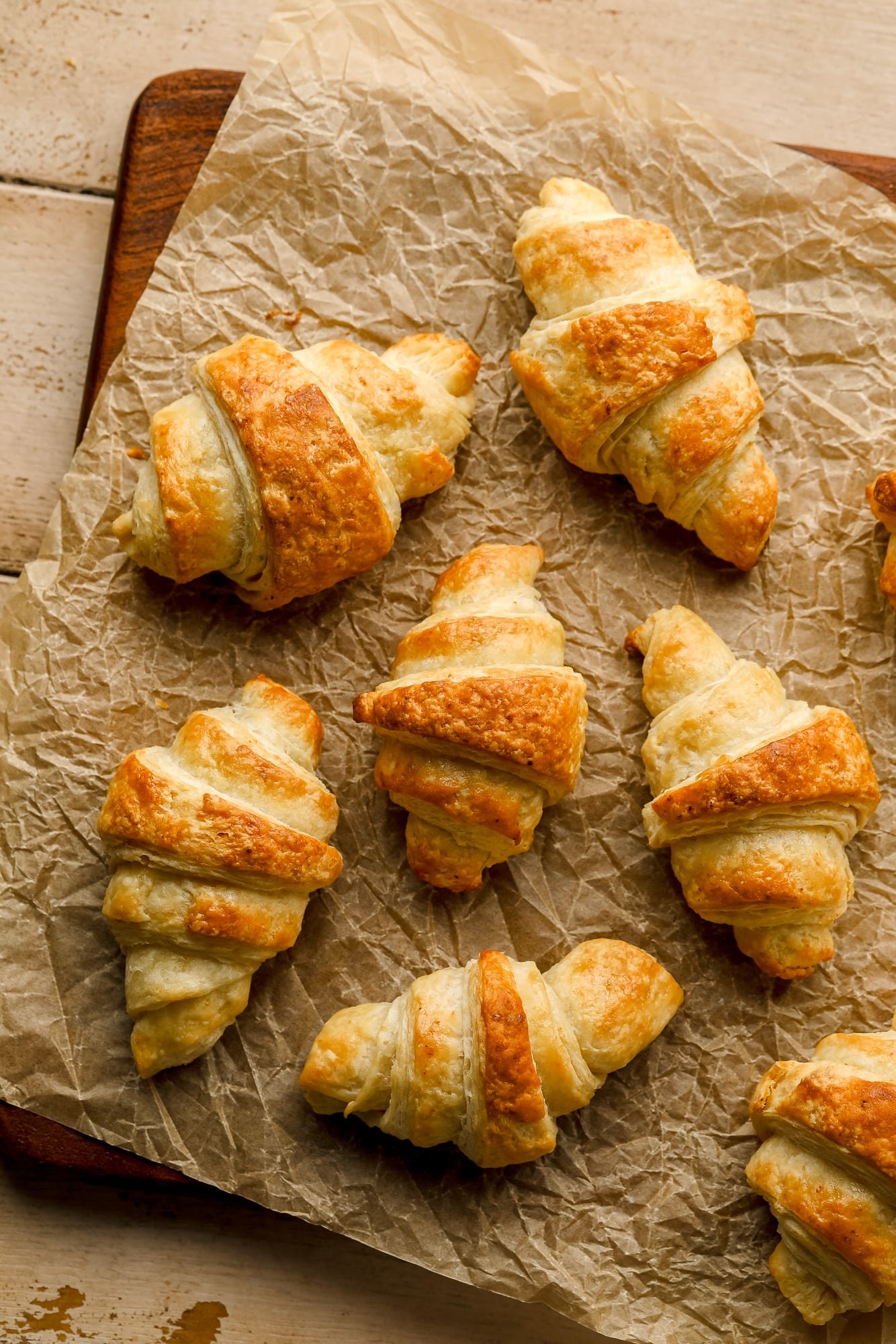 baked vegan croissants on a sheet of parchment paper.