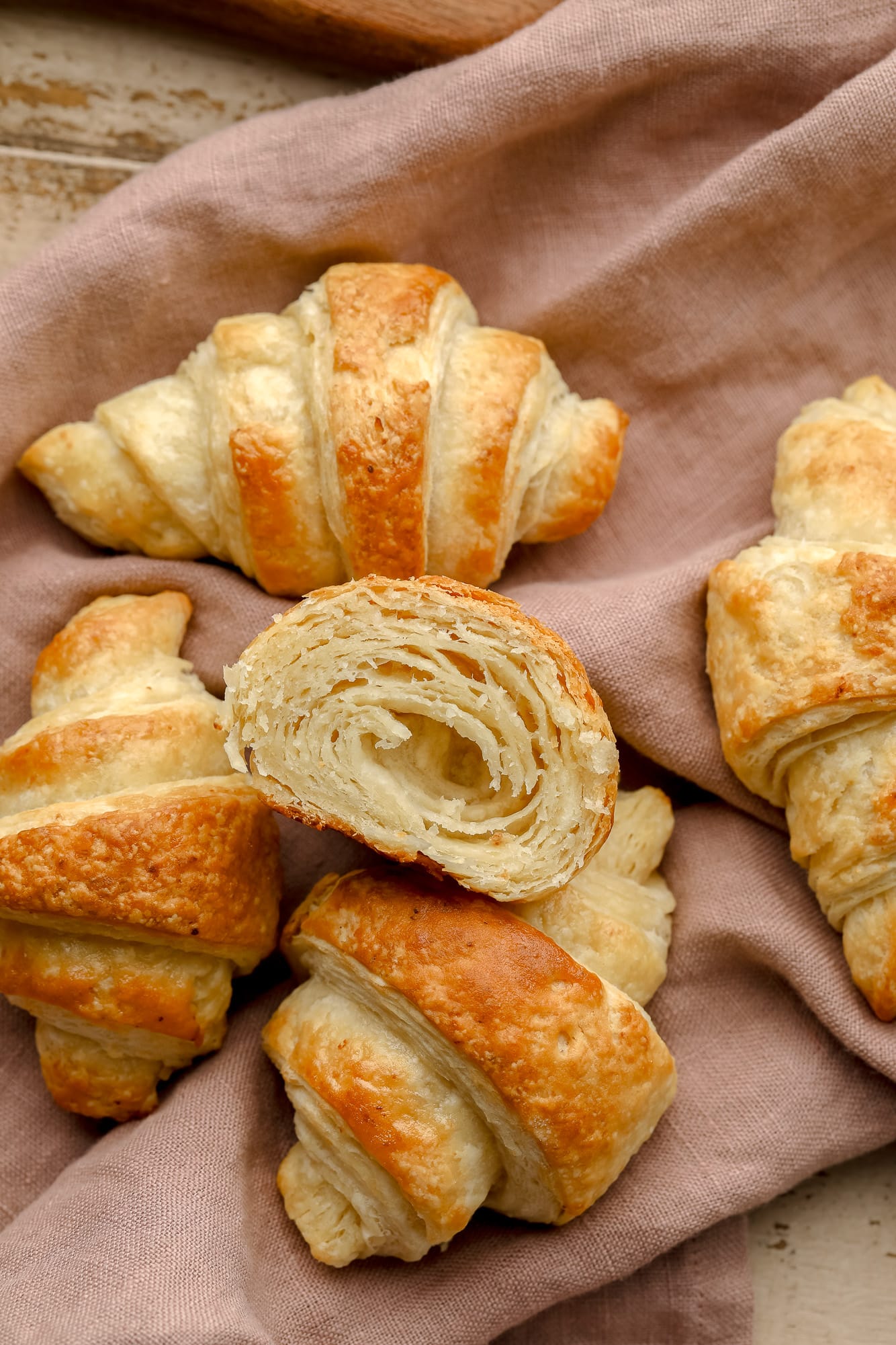 baked vegan croissants on a rose-colored kitchen towel.