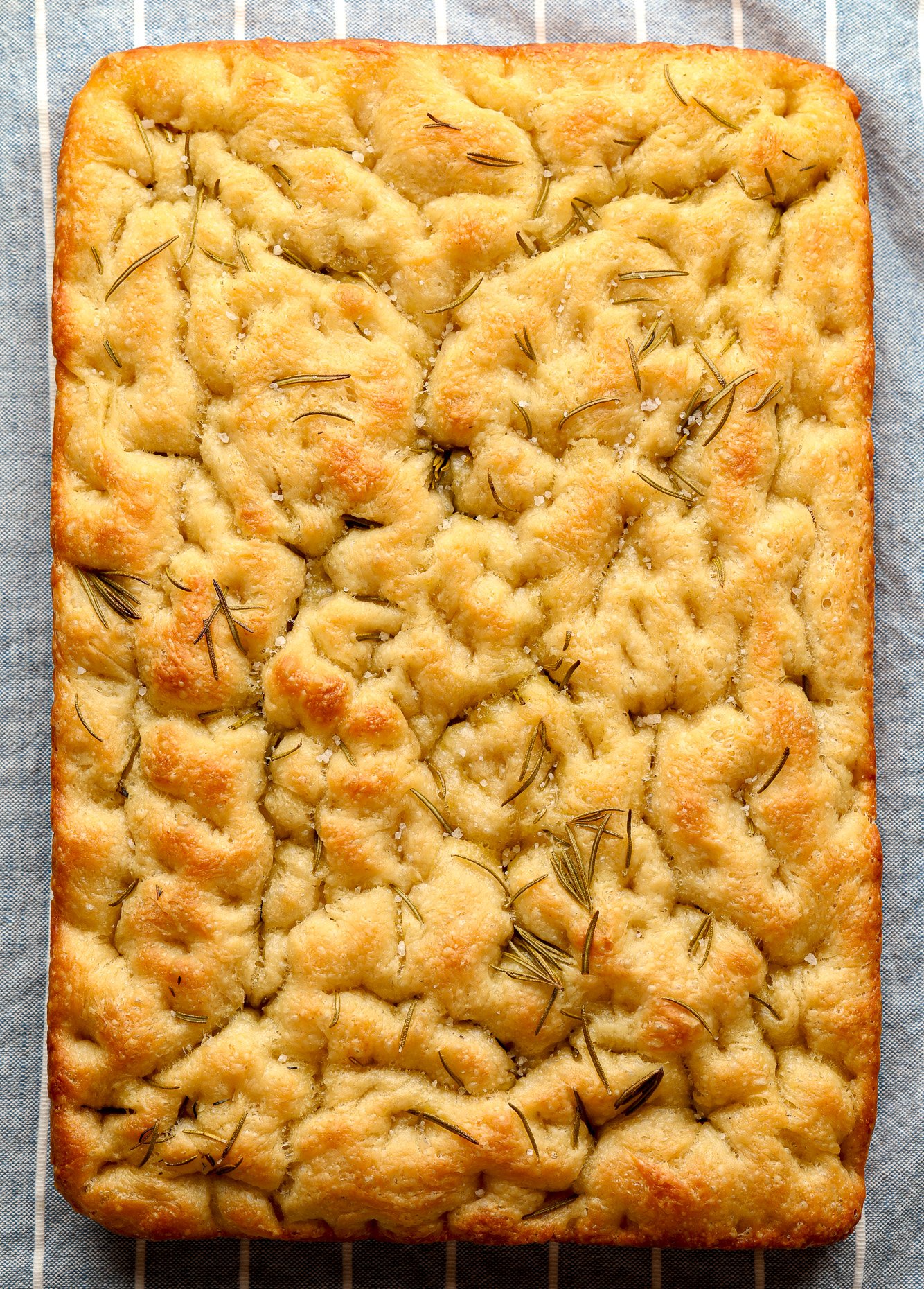 baked vegan focaccia with rosemary and salt on top.