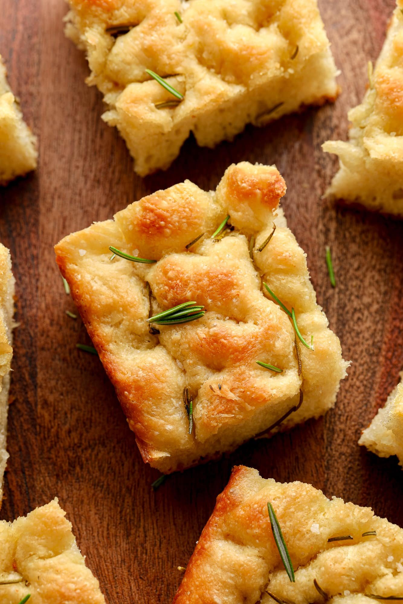 close up on a slice of vegan focaccia with rosemary on top.