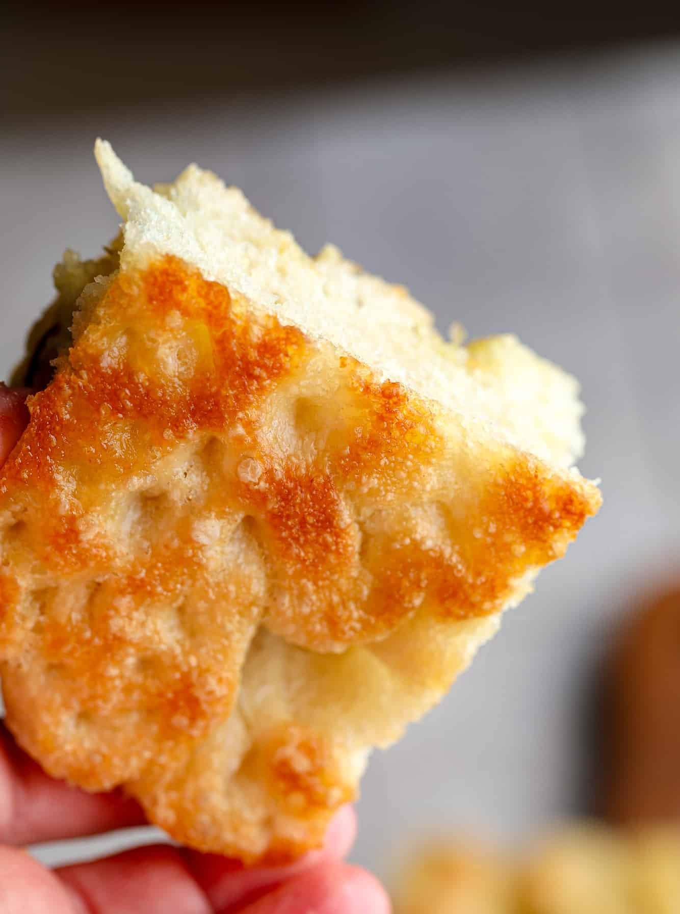 close up on the golden crispy bottom of a slice of focaccia bread.
