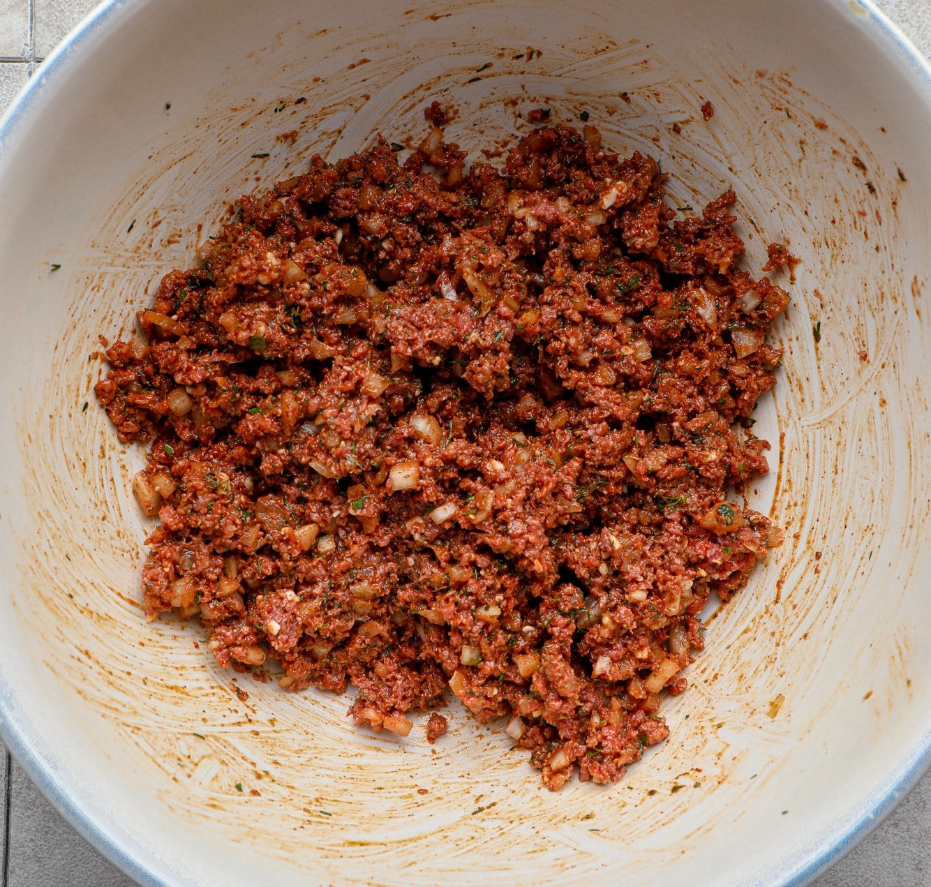 a spiced ground vegan meat mixture in a large white bowl.