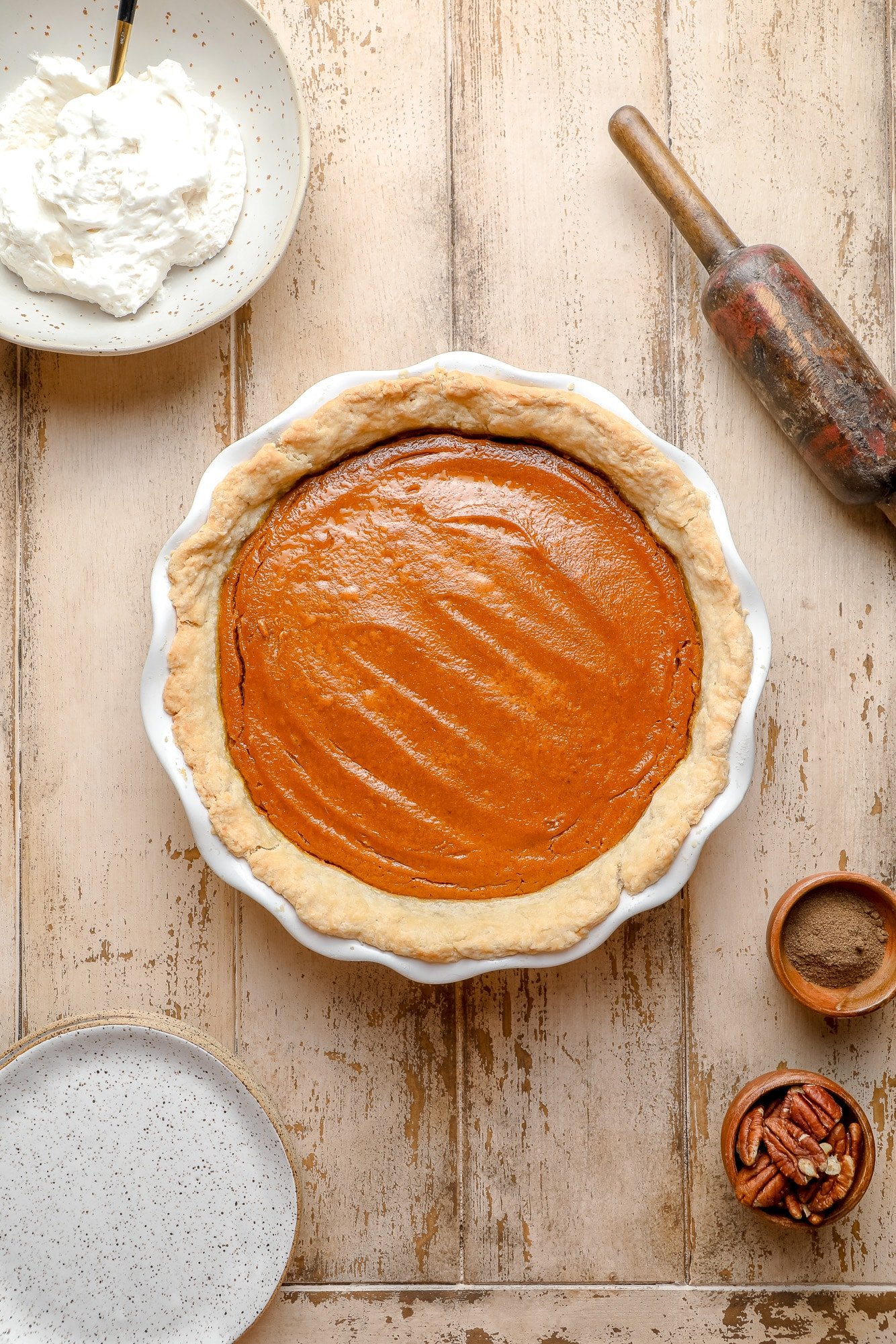 baked vegan pumpkin pie in a white pie dish.