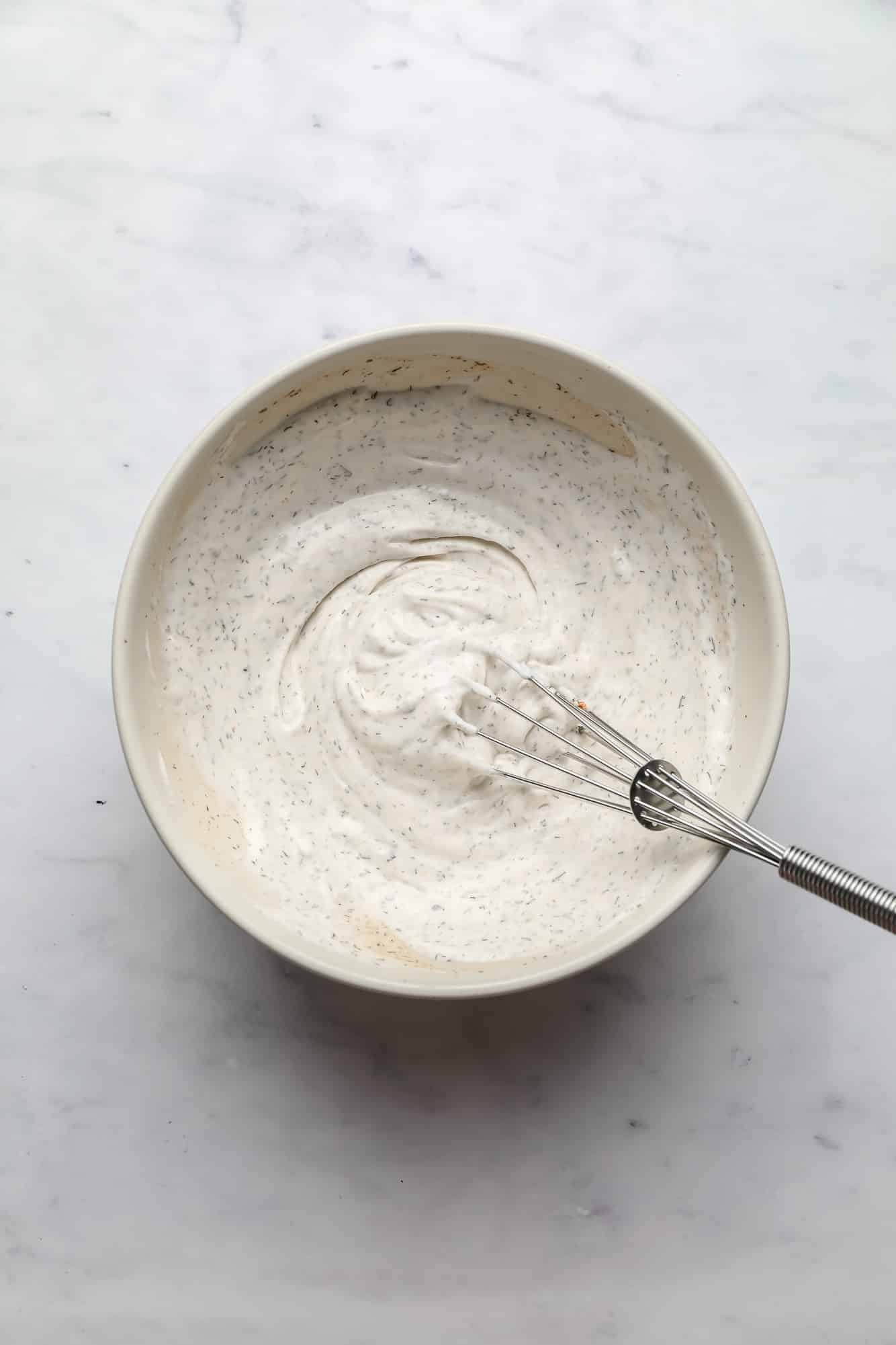 creamy vegan ranch dressing in a white bowl.