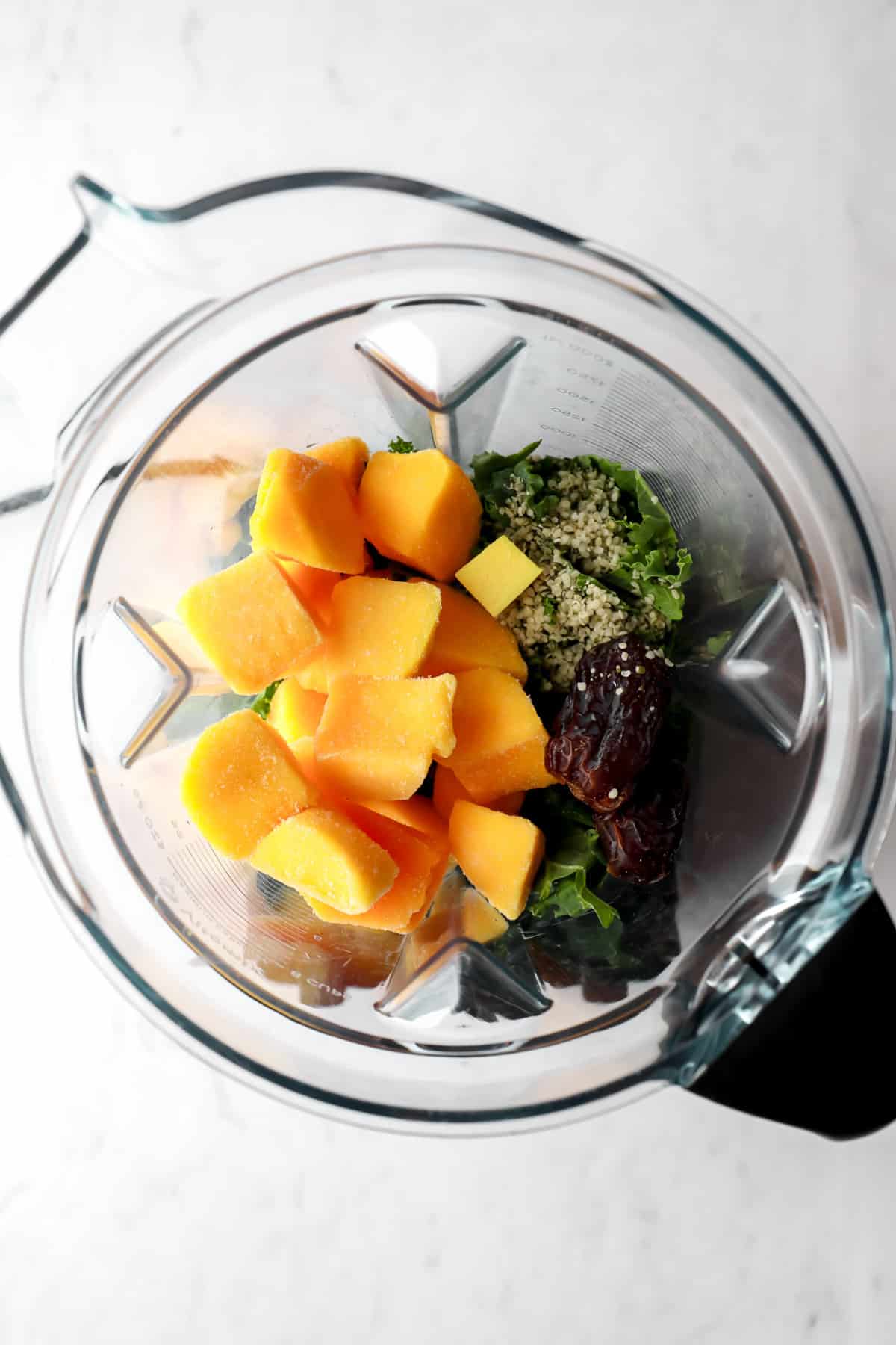 mango, kale, seeds and dates in a blender before blending