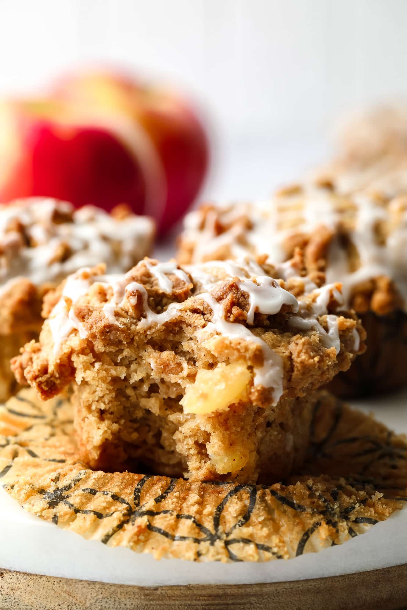 close up on a vegan apple muffin with a bite taken out of it.