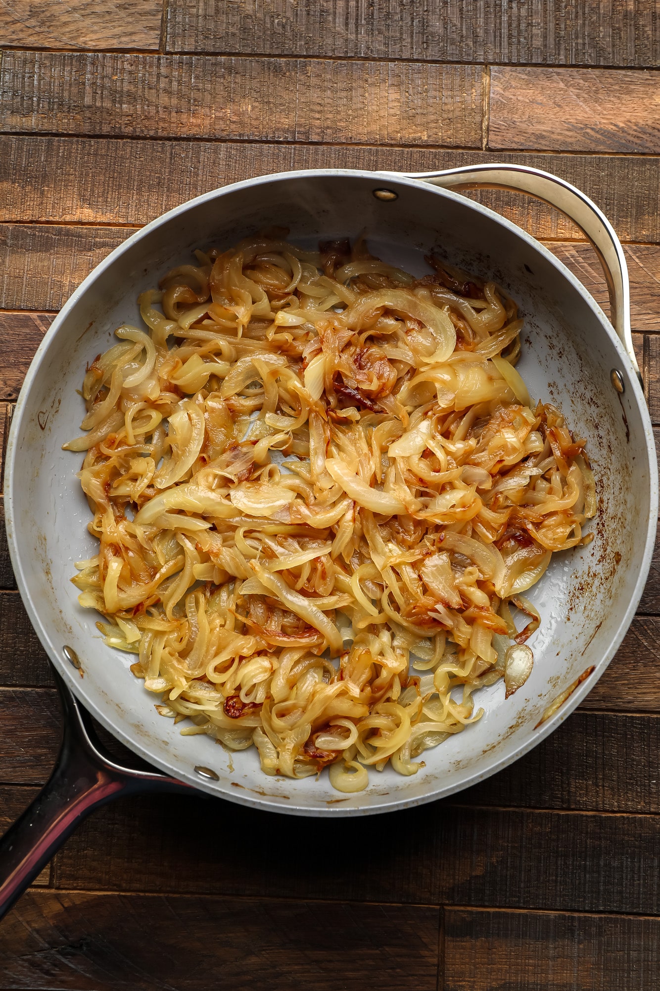 caramelized onions in a large grey skillet.