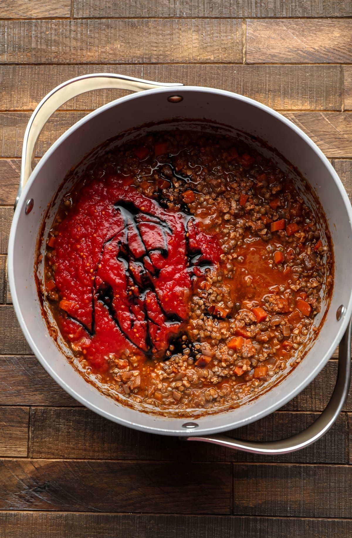 pot with lentils and red sauce in it, unstirred