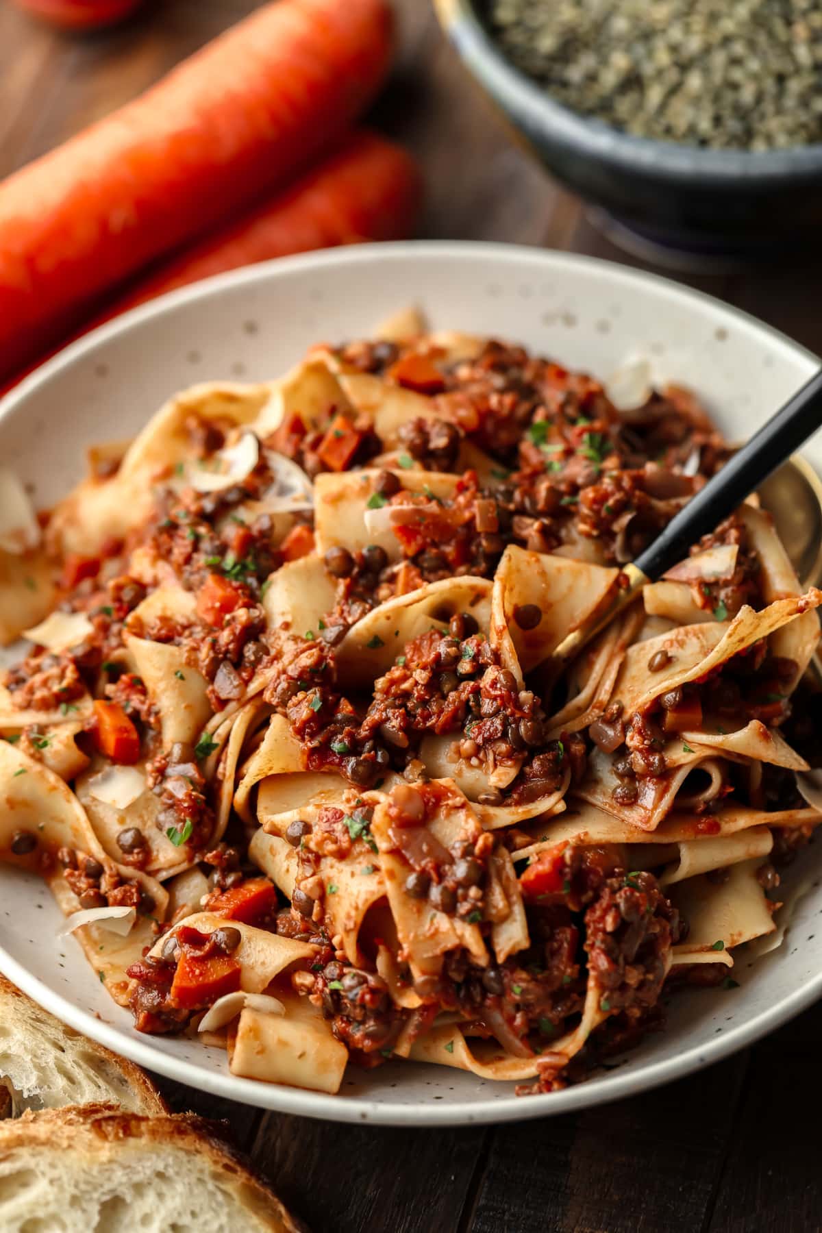 speckled bowl with a fork getting some lentil pasta on it