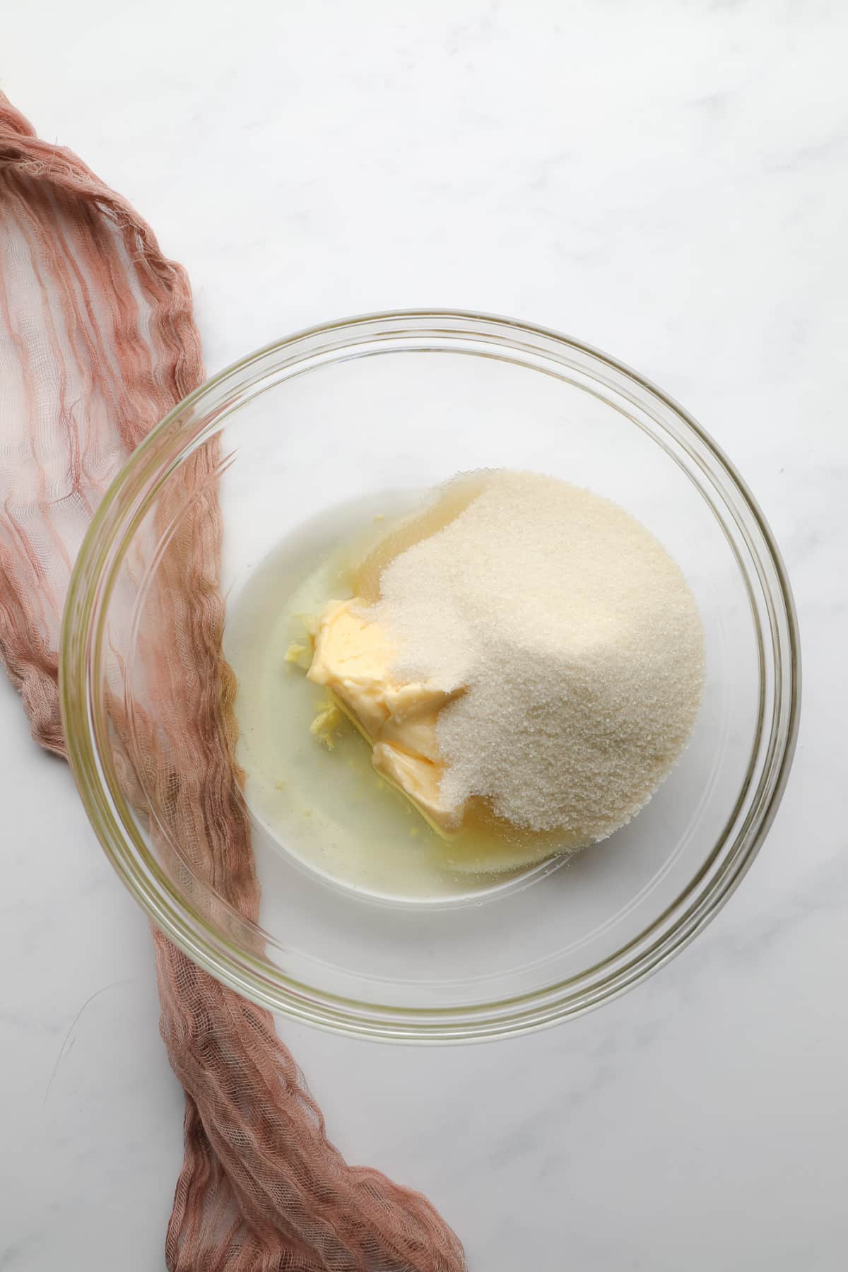 glass bowl with butter, sugar and oil, not mixed yet