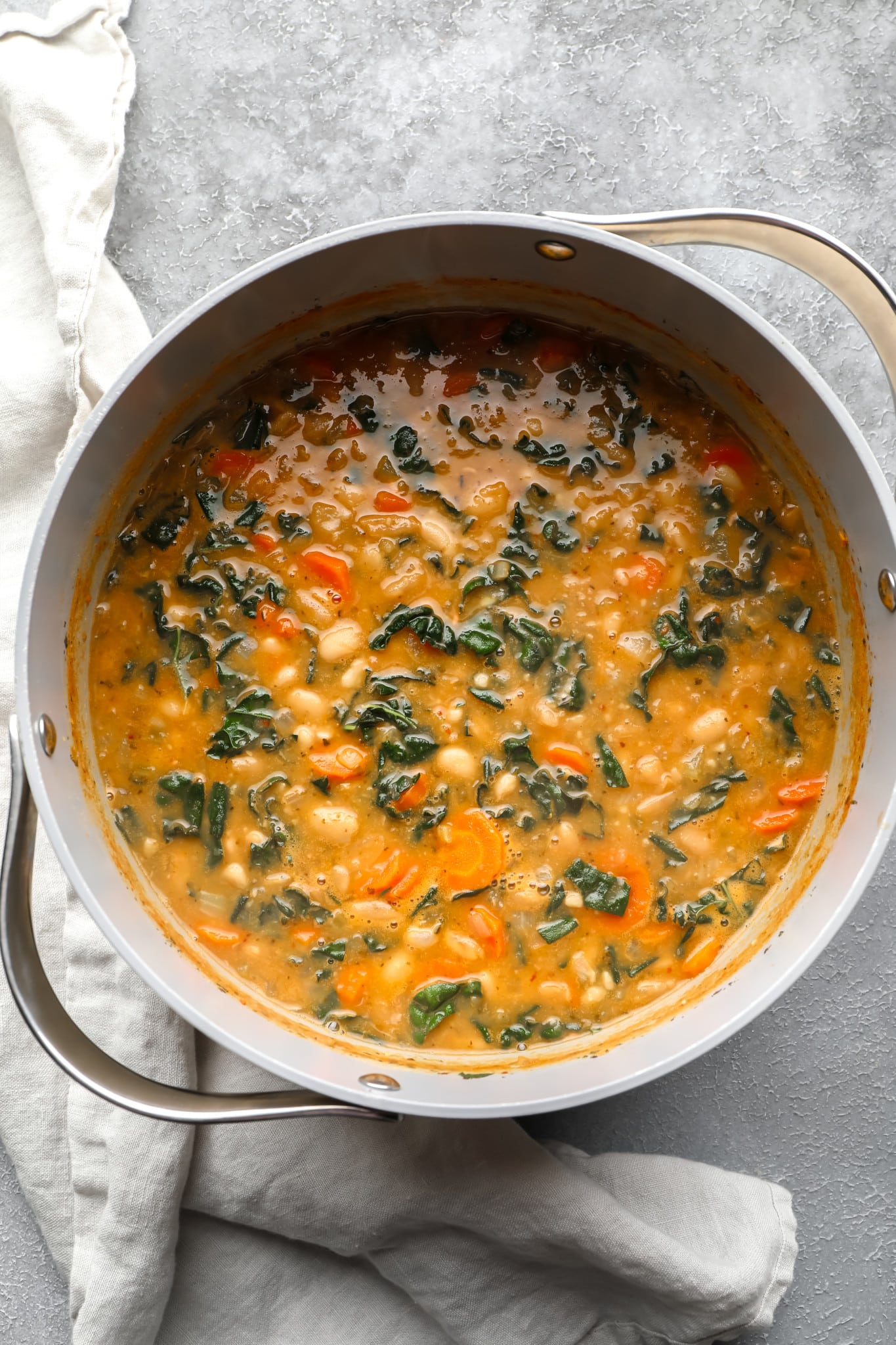 cooked white bean soup in a large grey pot.