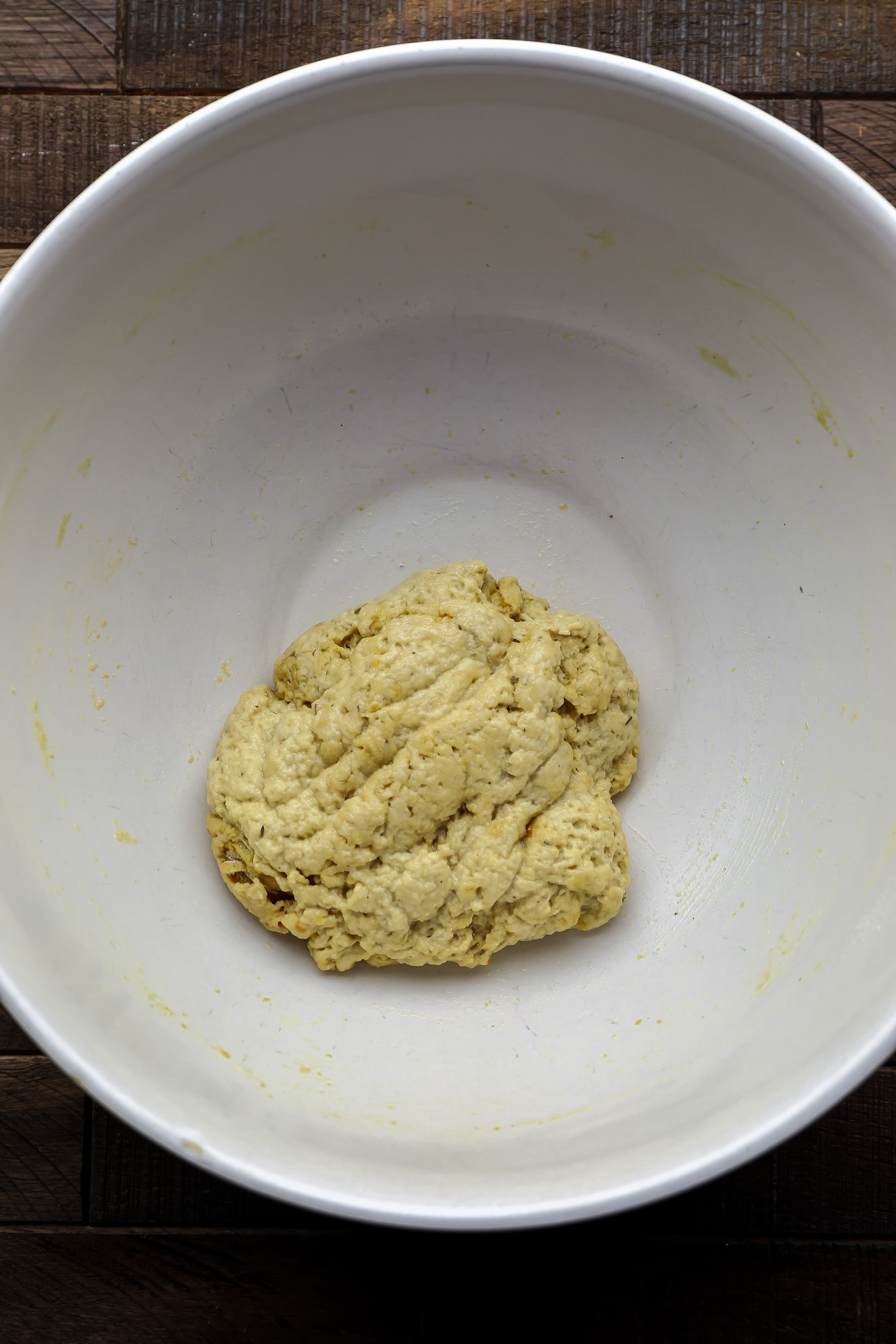 a ball of seitan dough in a large white bowl.