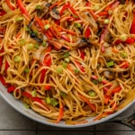 close up on a cooked batch of vegan lo mein in a large skillet.