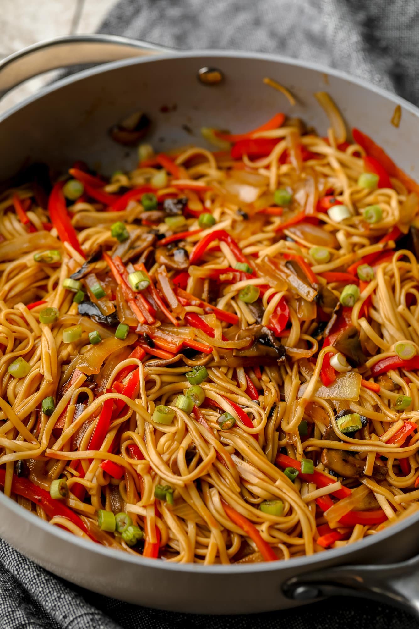 vegan lo mein in a large gray skillet.