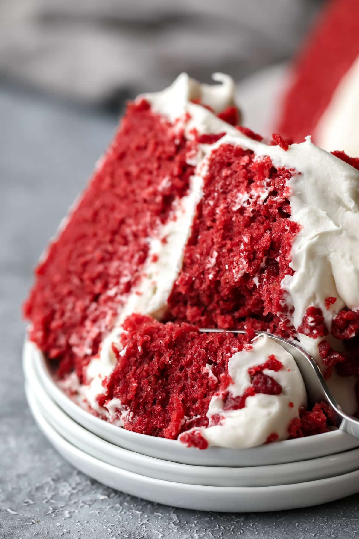 fork taking a bite out of vegan red velvet cake