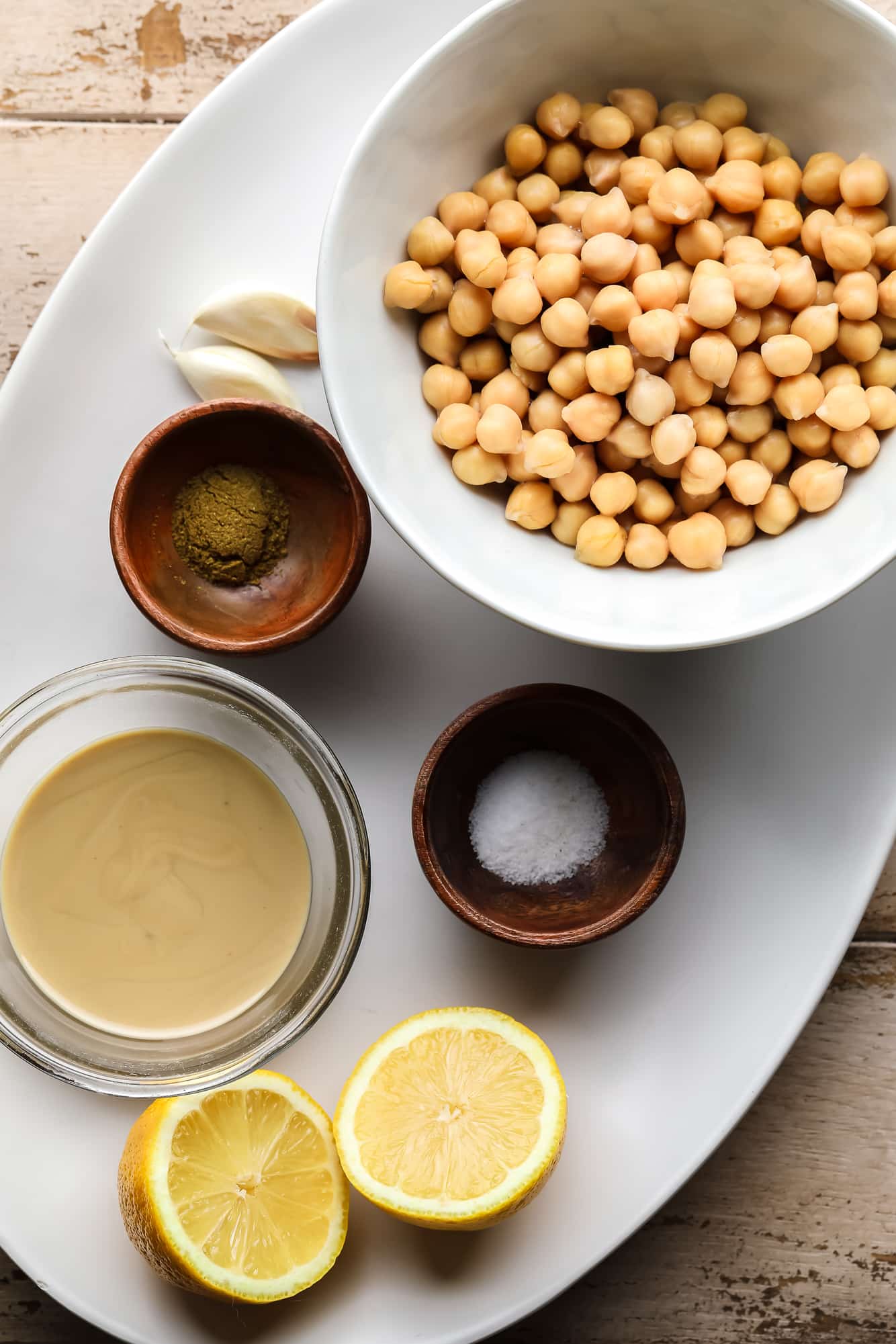 ingredients for hummus on a white plate.