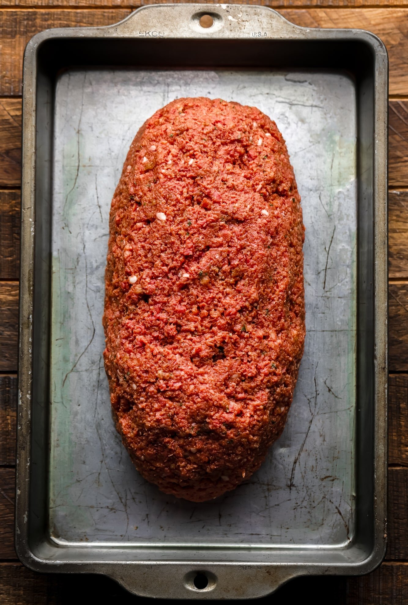 uncooked vegan Impossible meatloaf on a metal sheet pan.