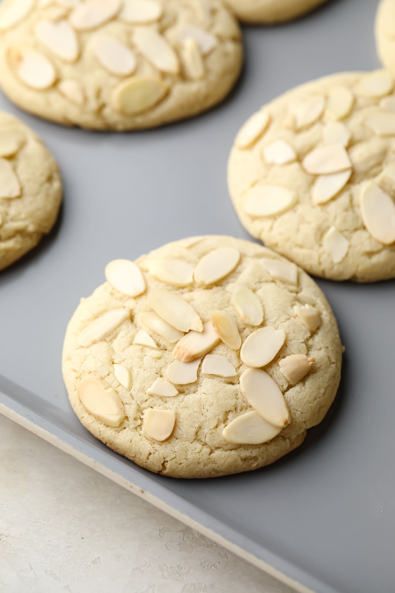 close up on baked Vegan Almond Croissant Cookies on a baking sheet.