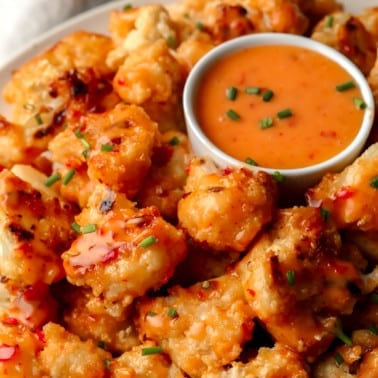 close up of bang bang cauliflower pieces on a plate