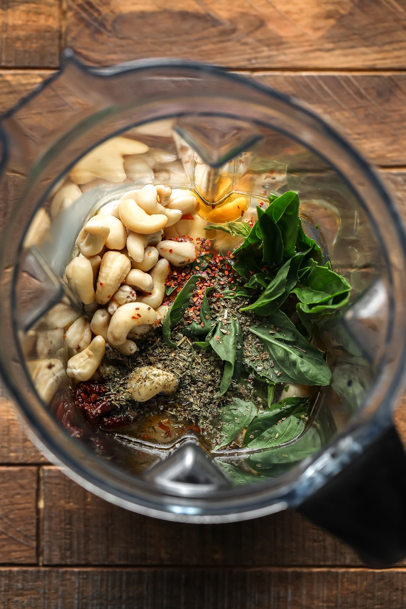 ingredients for a Tuscan cashew cream sauce in a blender.