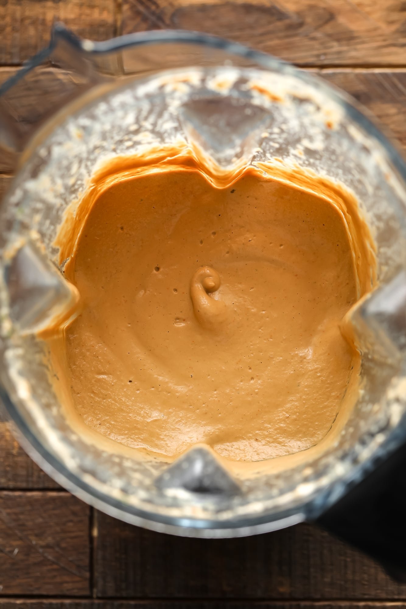 a creamy orange Tuscan sauce in a blender.