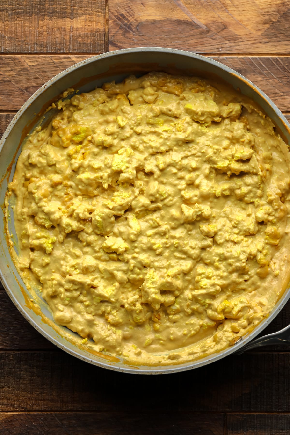 egg looking yellow mixture in pan on wood board