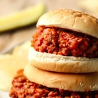 close up on two vegan sloppy joes served in hamburger buns.
