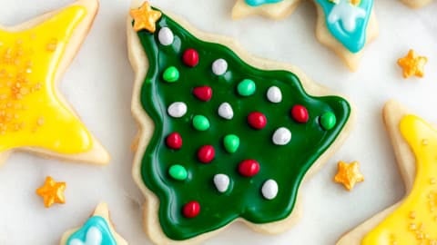 square image of laid flat vegan sugar cookies decorated with sprinkles and icing