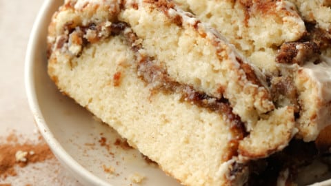 slices of Vegan Cinnamon Swirl Quick Bread on a beige plate.