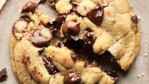 square image of a broken chocolate chip cookie