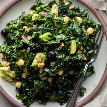 close up on a kale salad on a plate.