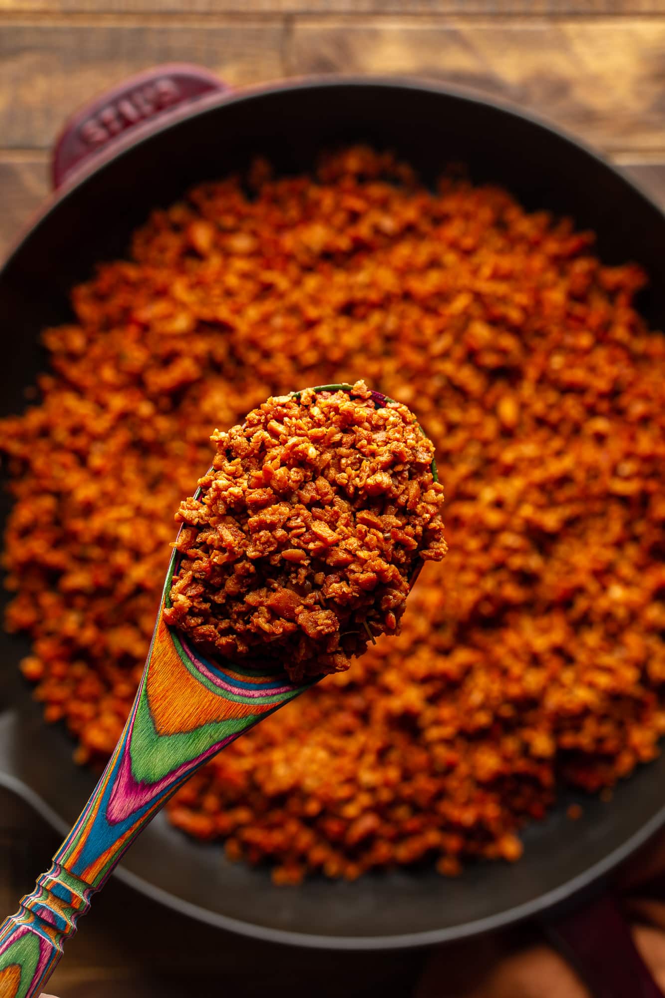 close up on a wooden spoon holding a scoop of vegan chorizo.