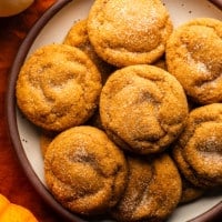 overhead view of a plate of cinnamon sugar-coated Vegan Pumpkin Snickerdoodles.