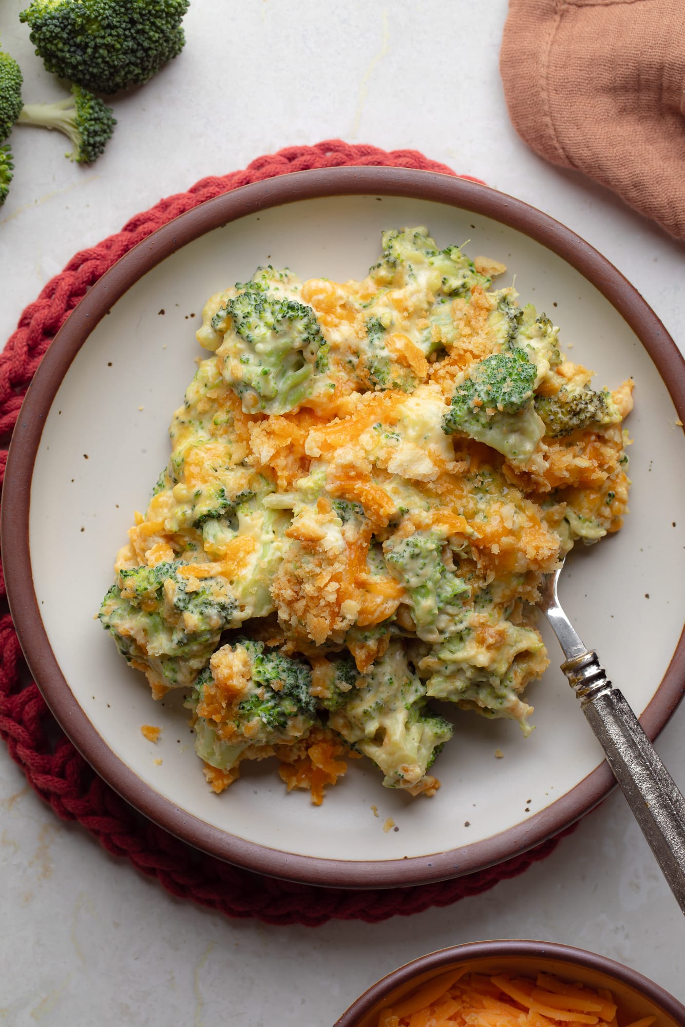 overhead view of a scoop of vegan broccoli casserole on a plate.