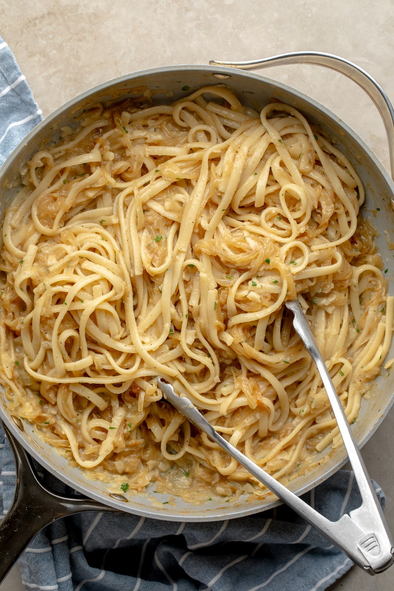 overhead view of a skillet full of vegan caramelized onion pasta.
