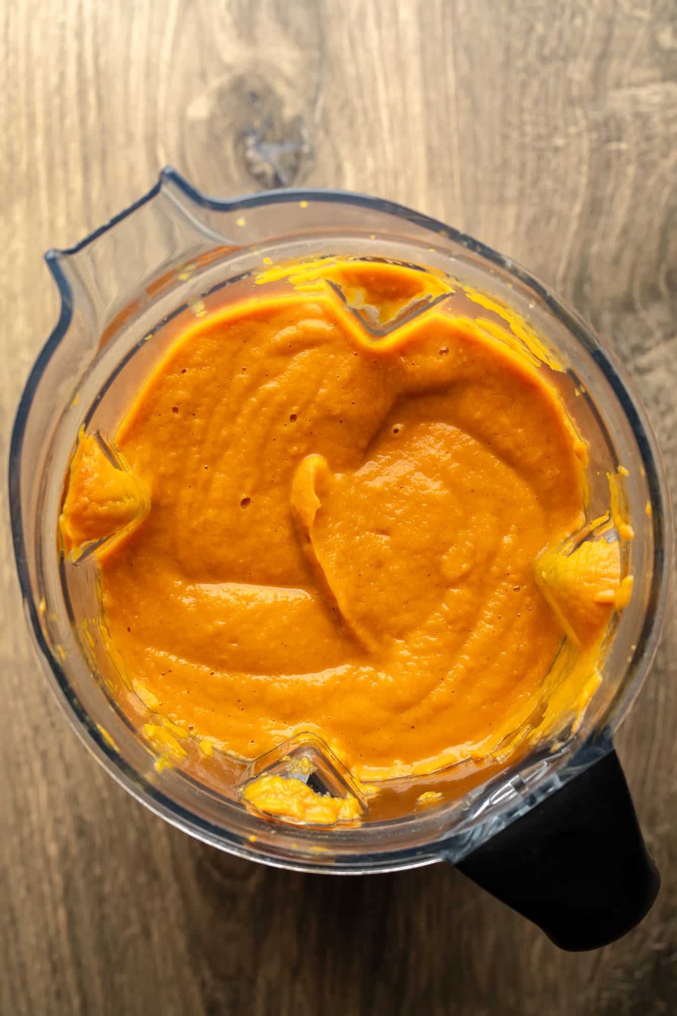 a blender full of smooth carrot and ginger soup.