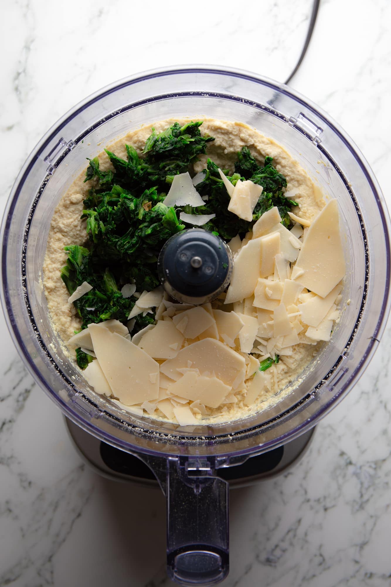 overhead view of the ingredients for vegan ricotta cheese in a food processor.