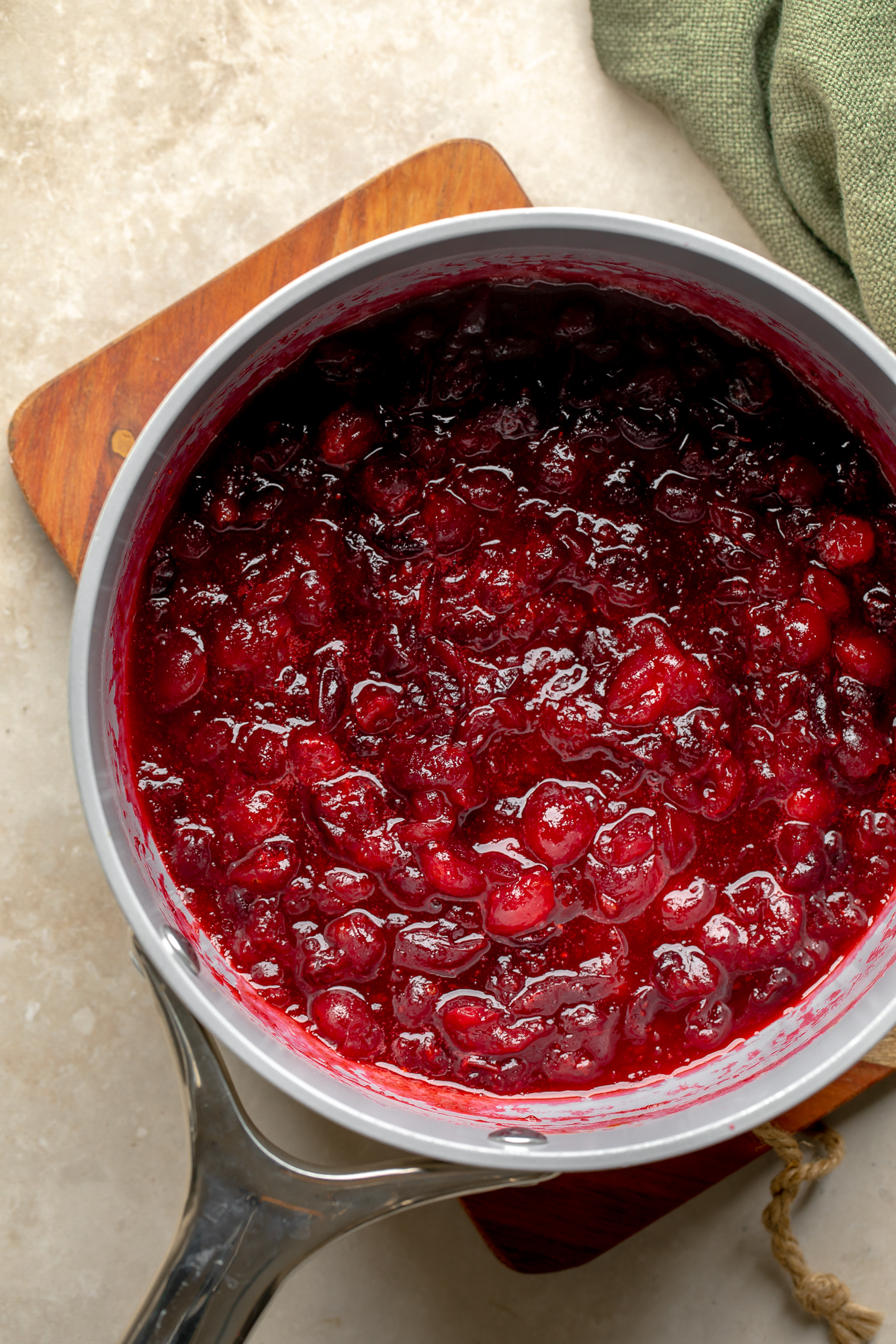 overhead view of orange cranberry sauce in a saucepan.