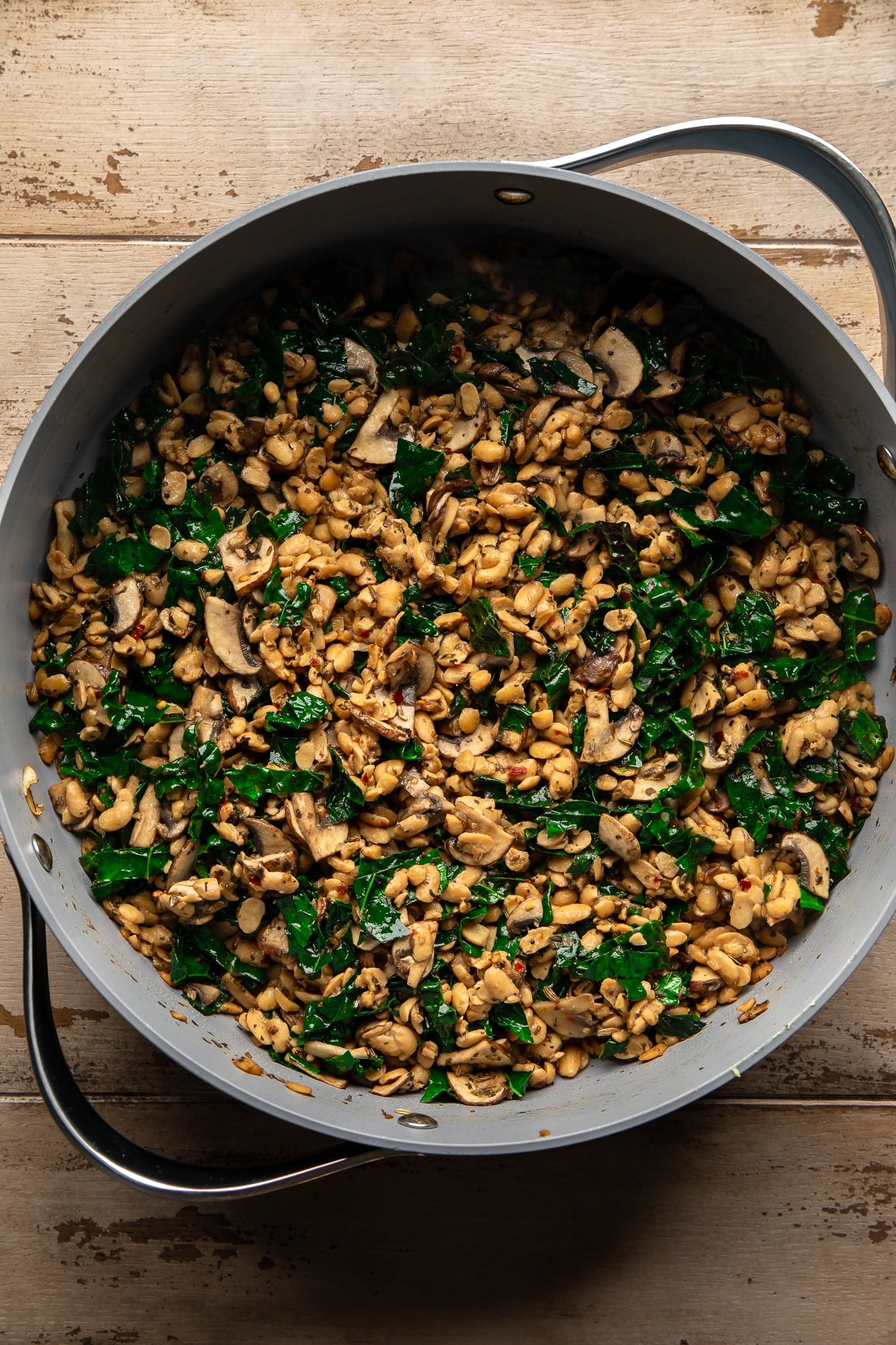 overhead view of a tempeh and wild rice stuffing for stuffed butternut squash in a large pot.