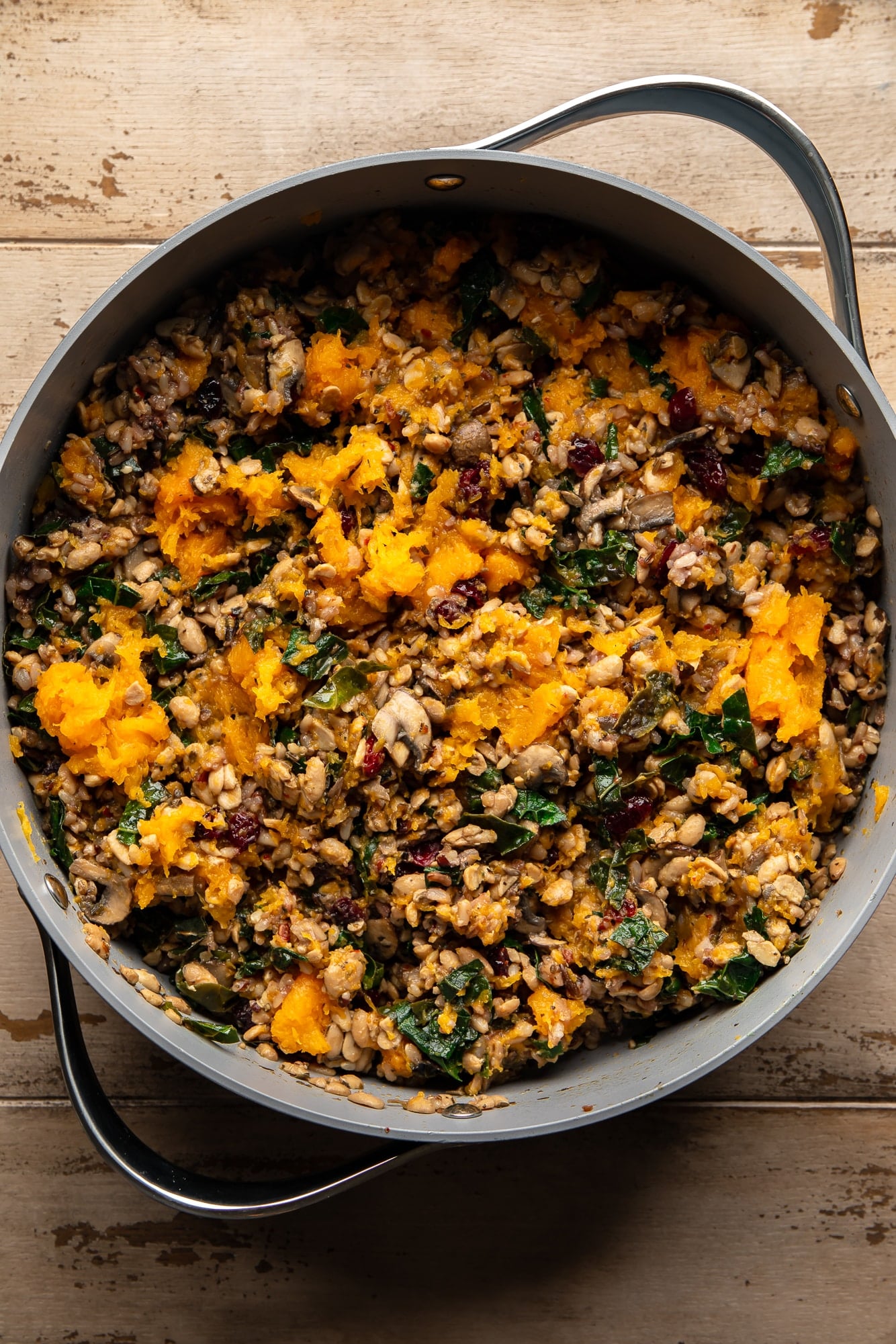 overhead view of a tempeh and wild rice stuffing for stuffed butternut squash in a large pot.