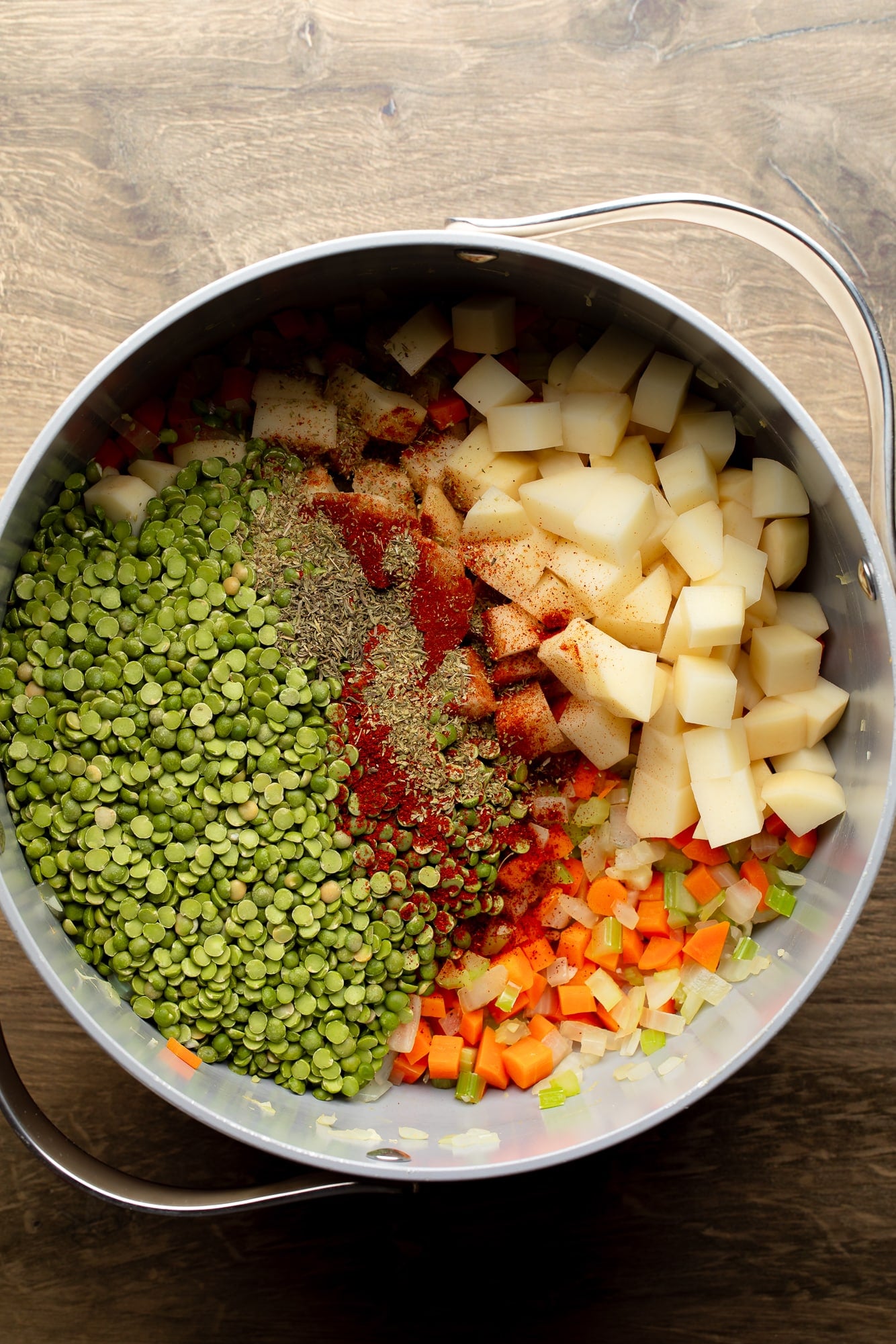 overhead view of the ingredients for vegan split pea soup in a large pot.