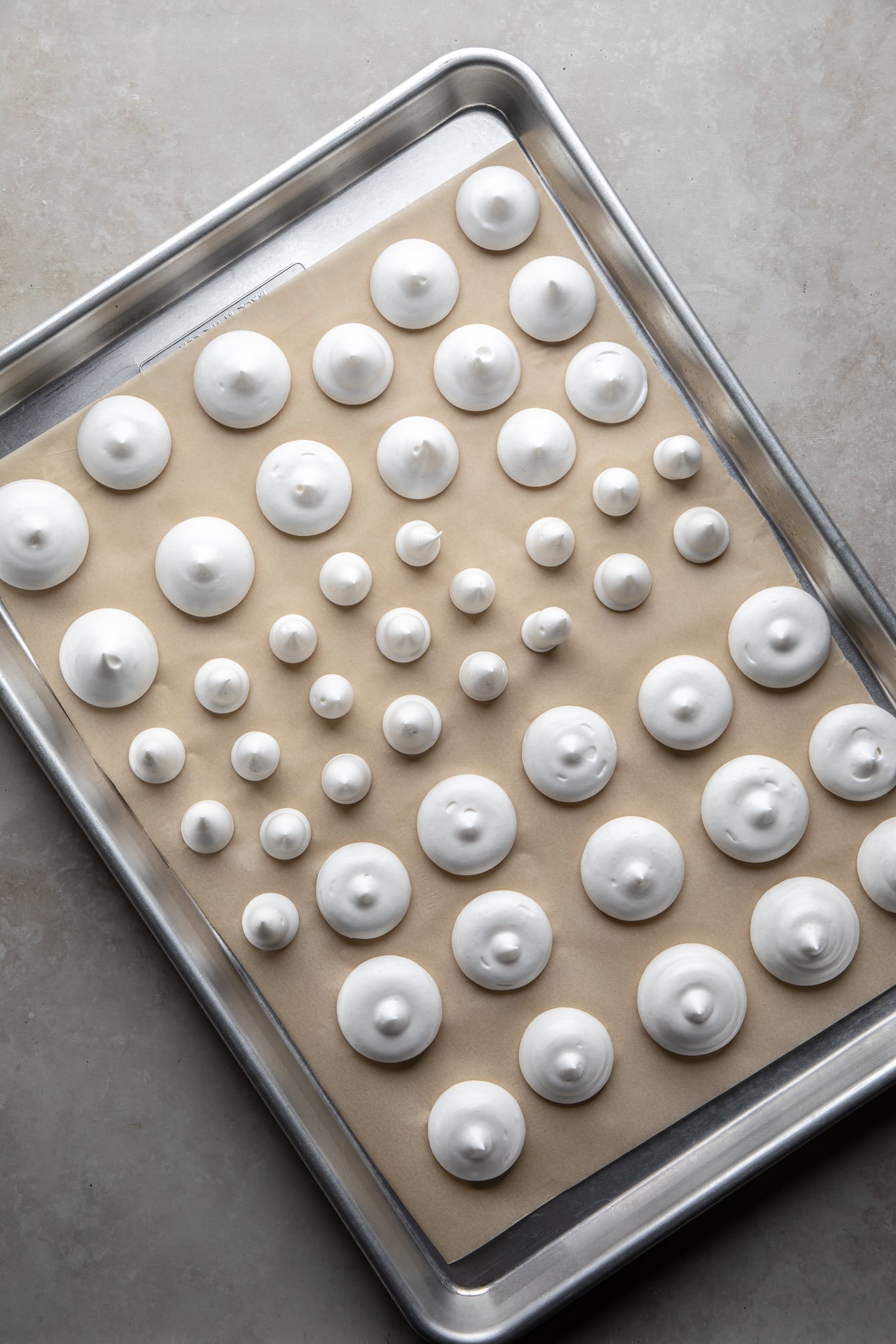 overhead view of vegan meringues on a baking sheet.