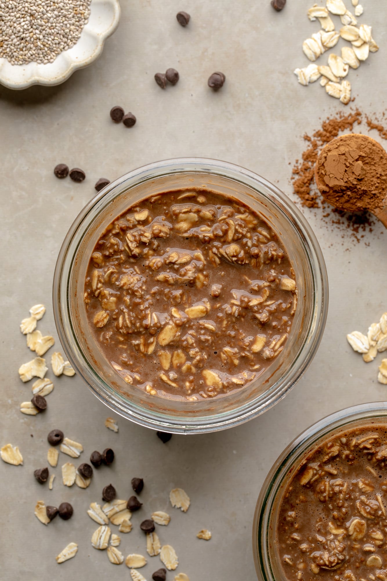 overhead view of chocolate overnight oats in a glass jar.