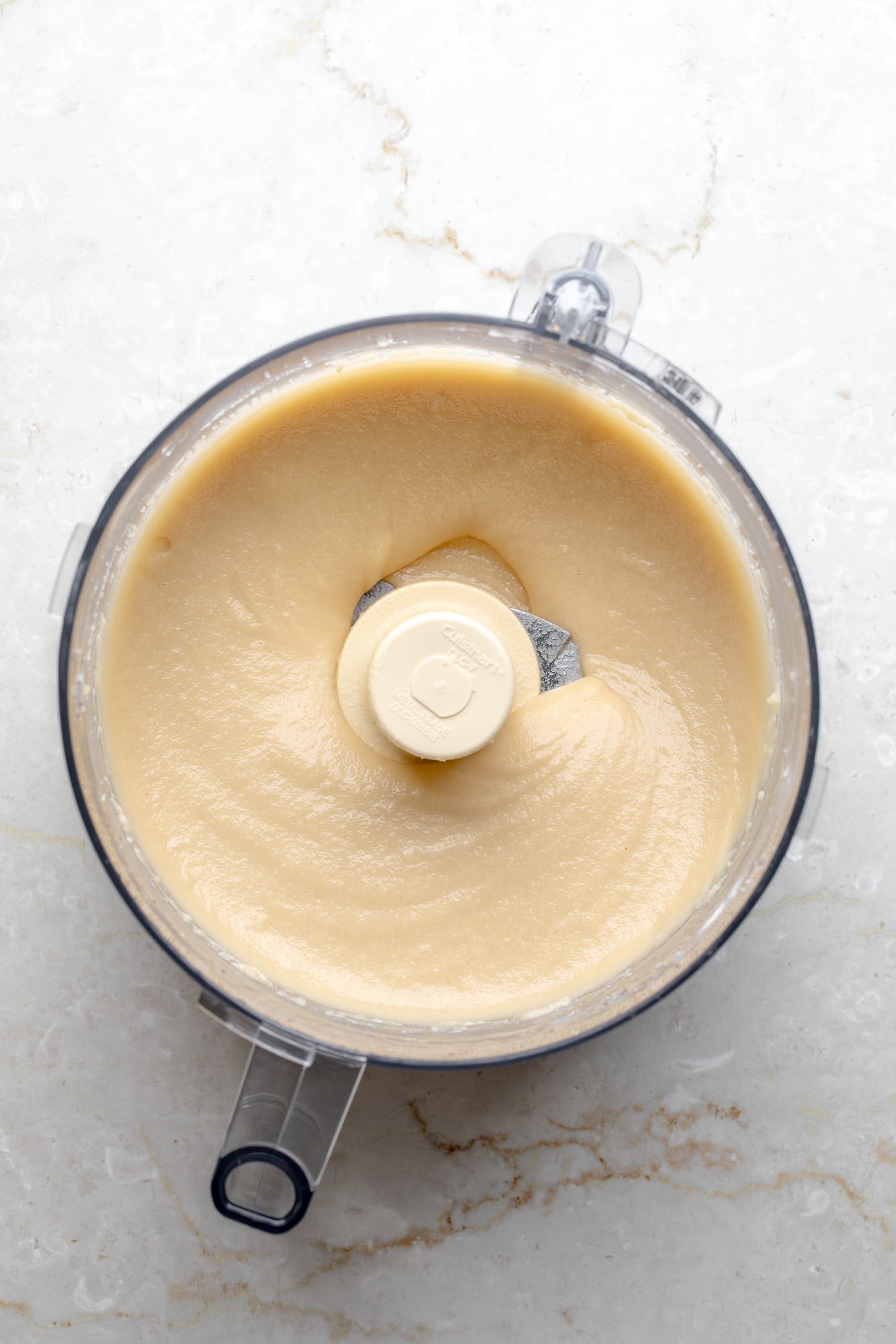 overhead view of almond frangipane in a food processor.