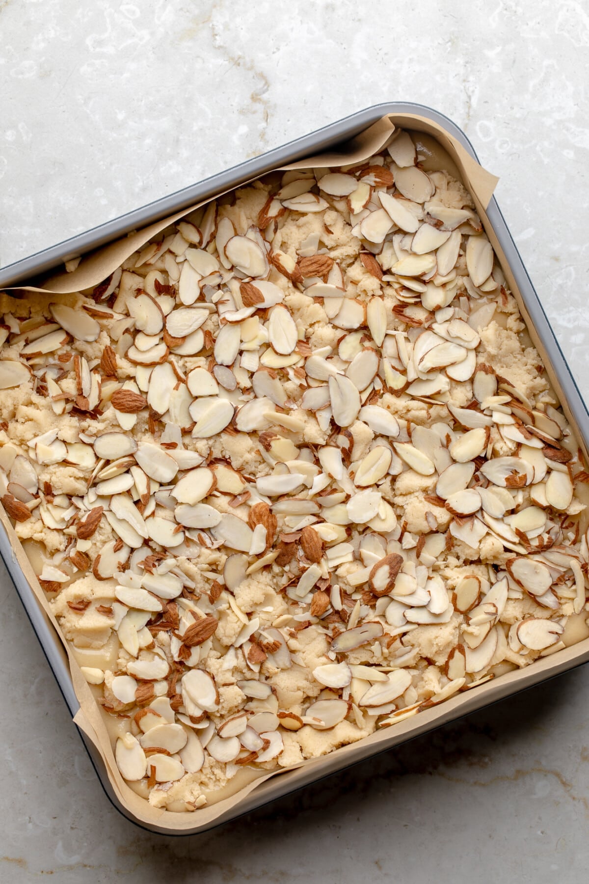 overhead view of unbaked vegan almond croissant bars in a baking pan.